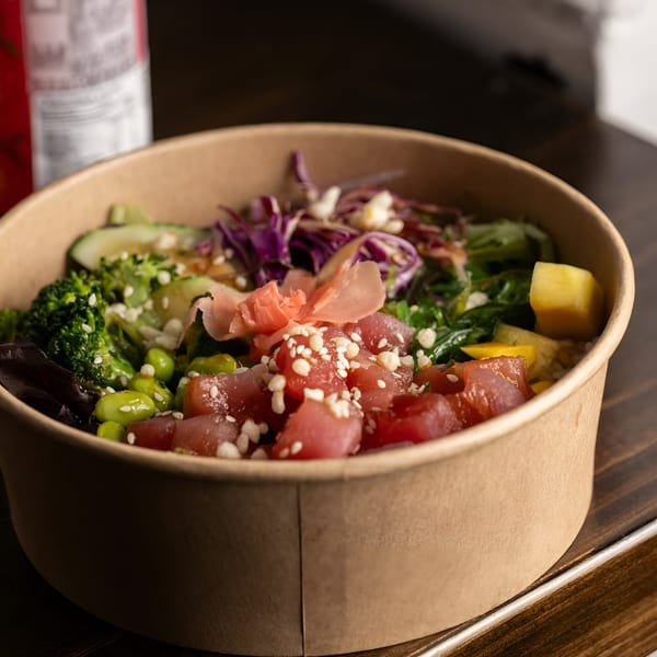 A Yum Yubu poke bowl with tuna, broccoli, edamame, avocado, red cabbage, and pickled ginger.