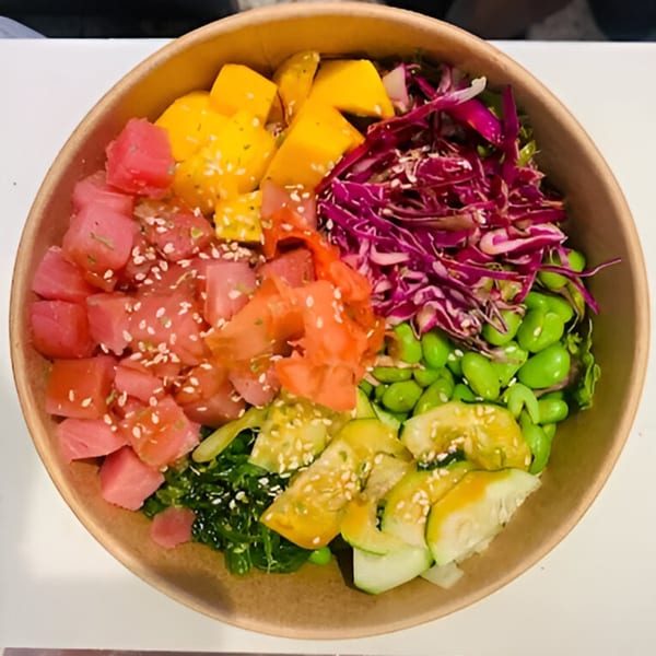 Colorful Yum Yubu poke bowl with tuna, mango, red cabbage, edamame, and cucumber.