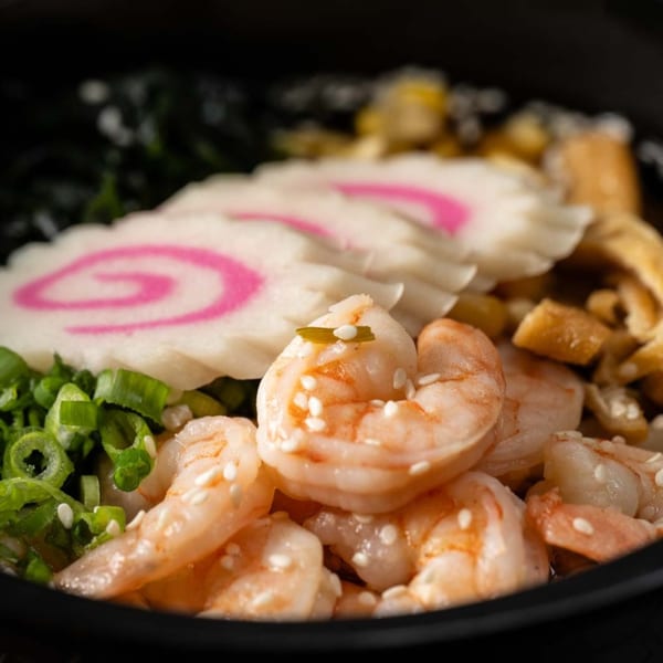 Shrimp poke bowl with narutomaki, green onions, and sesame seeds from Yum Yubu.